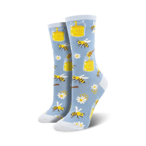 Pair of women's crew socks in light blue and orange. The socks feature a whimsical design of bees, honey jars, daisies and honeycomb.