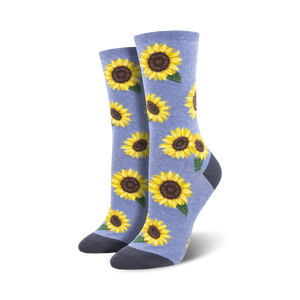 Lifestyle shot showing a person wearing the light blue sunflower socks. The socks look soft and comfy and are stylishly paired with other clothing items