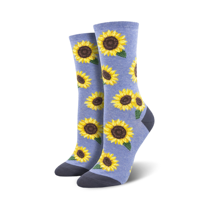 Lifestyle shot showing a person wearing the light blue sunflower socks. The socks look soft and comfy and are stylishly paired with other clothing items