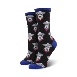 Pair of black crew socks with a repeating pattern of miniature schnauzers wearing sailor hats.  The socks have royal blue cuffs.