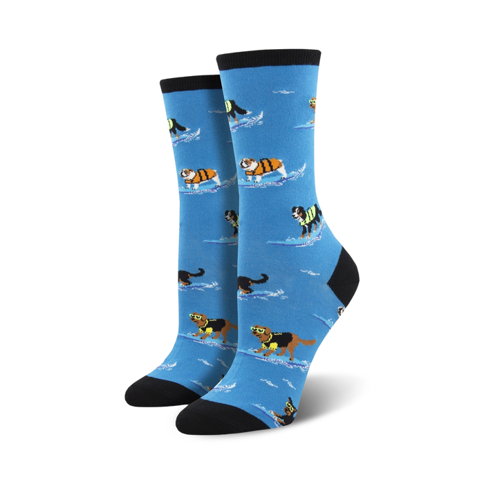 Pair of women's crew socks. Light blue background, dogs surfing in life vests, black and cream colored cuffs.