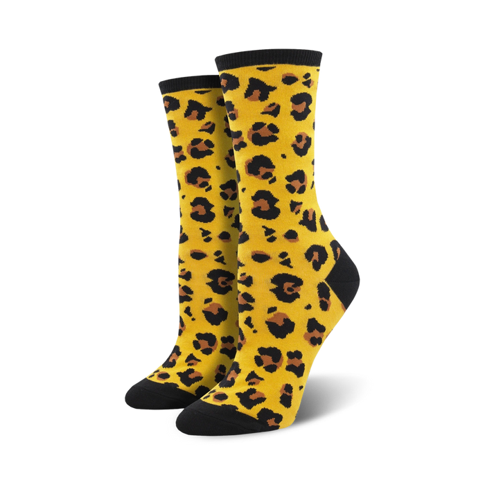 Pair of women's crew socks in mustard yellow with a black leopard print. Black toe and heel. }}