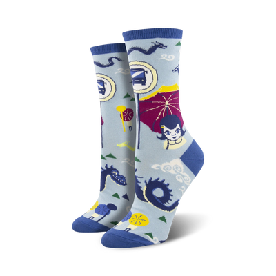 Women's crew socks in light blue and teal, featuring an illustrated bus stop scene with dragons, parasols, and a girl. Fun and quirky design!