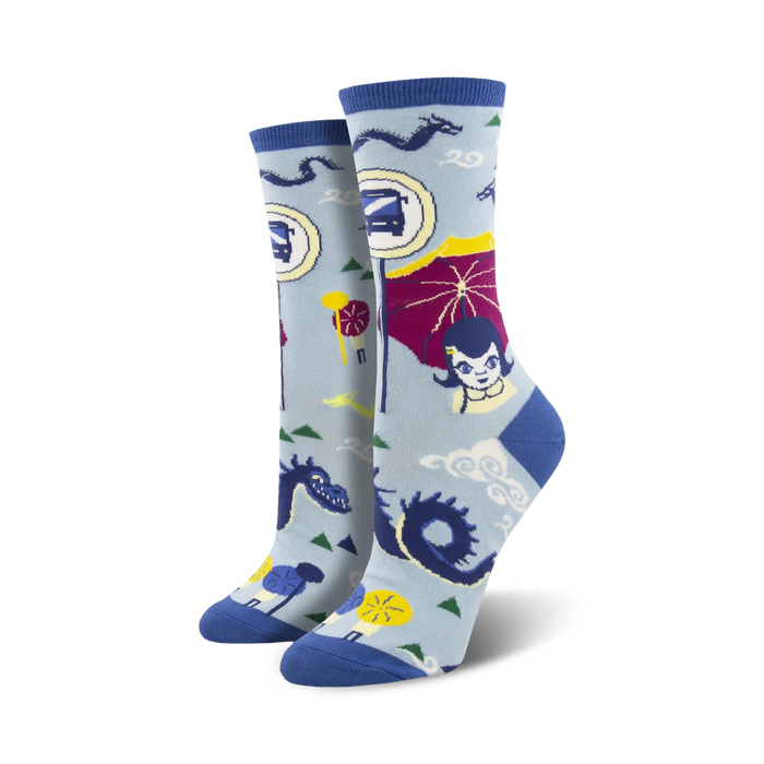Women's crew socks in light blue and teal, featuring an illustrated bus stop scene with dragons, parasols, and a girl.  Fun and quirky design!