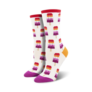 Pair of crew socks with a white background and repeating pattern of lesbian flag-colored popsicles.  Red, orange, purple, and white popsicle design; purple and orange heel and toe.