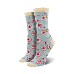 Lifestyle shot of a woman's feet wearing light blue cherry blossom socks.