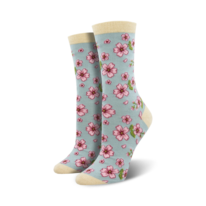 Lifestyle shot of a woman's feet wearing light blue cherry blossom socks.