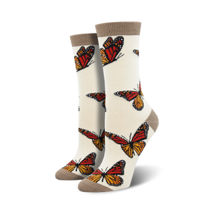 Pair of cream women's crew socks adorned with orange and brown monarch butterfly prints.  Features a subtle taupe cuff.
