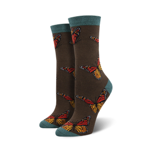 Close-up of a pair of dark brown crew socks with teal cuffs, showcasing the monarch butterfly design.