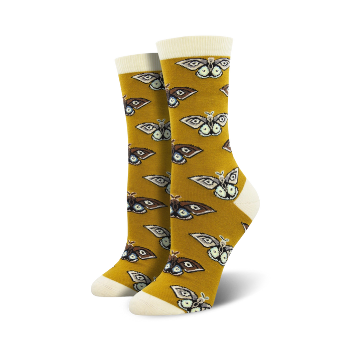 Pair of women's crew socks. Mustard yellow background with repeating brown and cream moth pattern.  Soft bamboo fabric.
