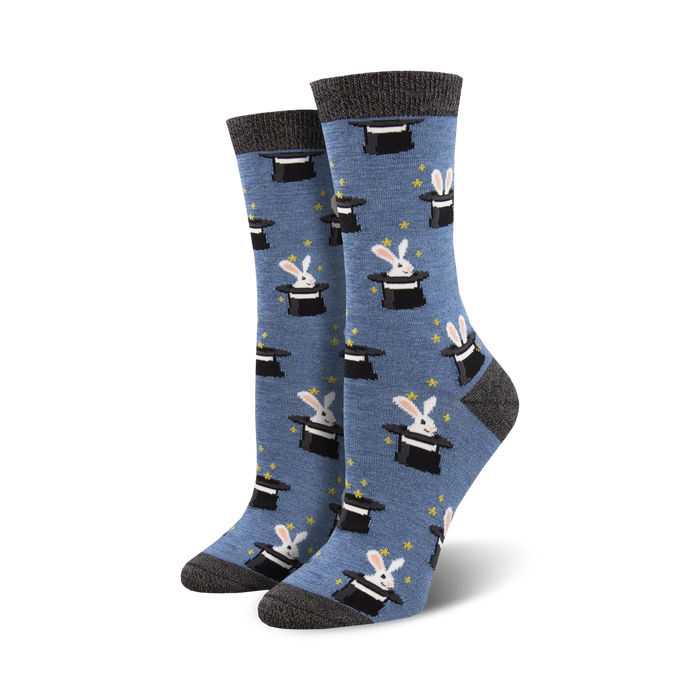 A pair of women's crew socks in blue with a pattern of white rabbits popping out of black top hats. }}