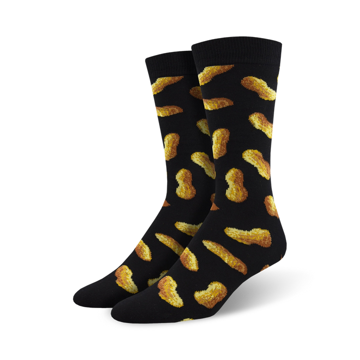 Pair of black crew socks with a whimsical all-over print of golden brown peanuts. }}
