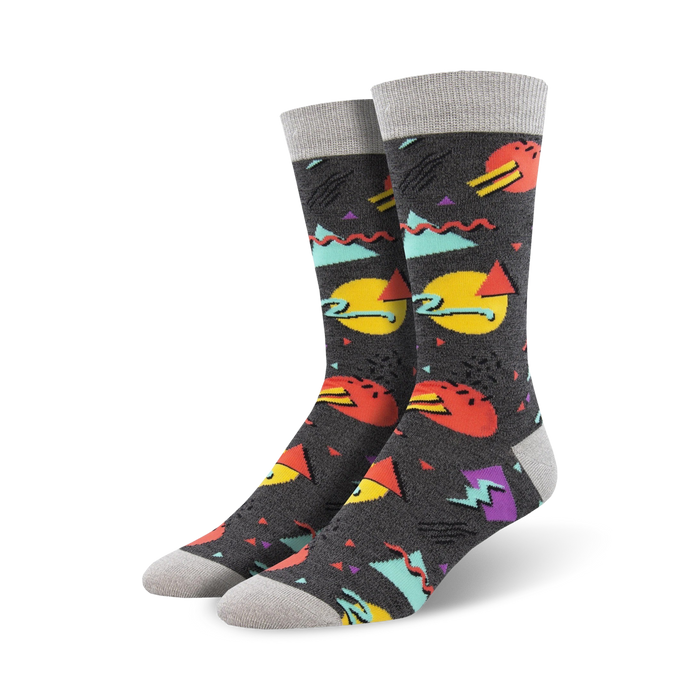 dark gray socks with colorful geometric shapes (triangles, squares, circles) in red, yellow, blue, and green inspired by 90s fashion. (crew).    }}