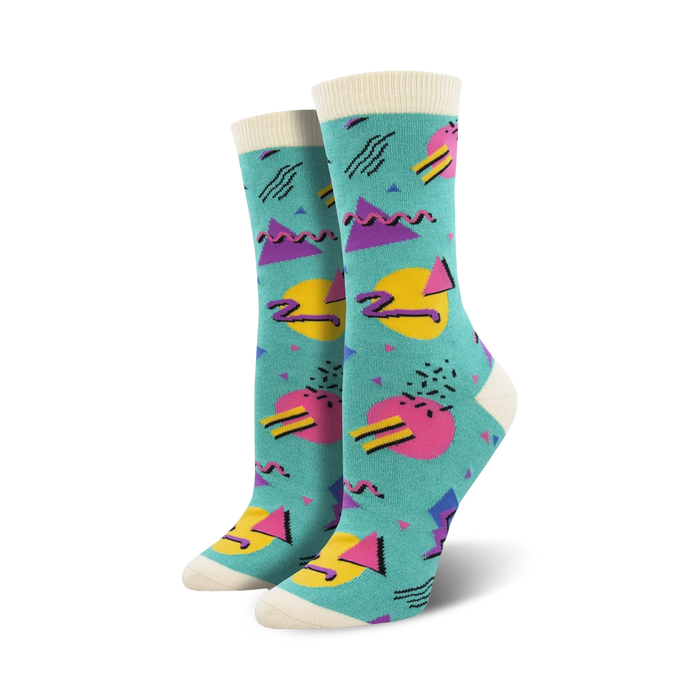 Pair of crew socks with a teal background and multicolored 90s-inspired geometric patterns.  The socks have a cream-colored cuff. }}