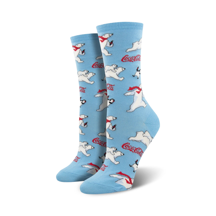 A pair of women's crew socks in light blue. The socks are covered in a pattern of polar bears wearing red scarves, penguins, and Coca-Cola logos. }}