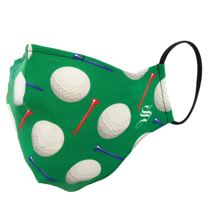 A green face mask with a pattern of golf balls and tees. The mask is made of cotton and has a black elastic ear loop.
