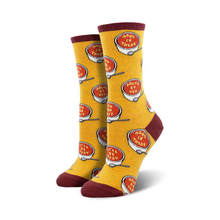 Pair of crew socks; yellow background with red soup bowls that say 'Hang in there' and 'Proud of you'.