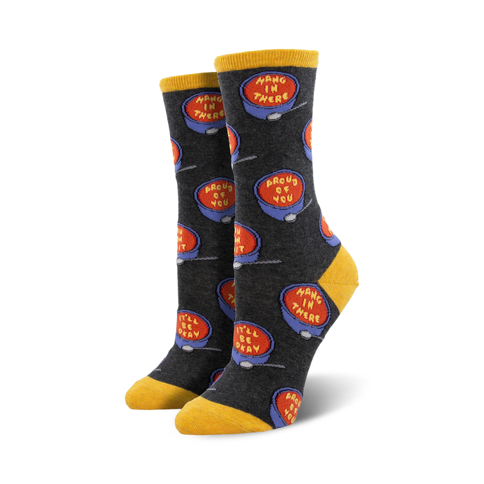 Close-up of a pair of dark gray crew socks with the same soup bowl design, but on a darker background.