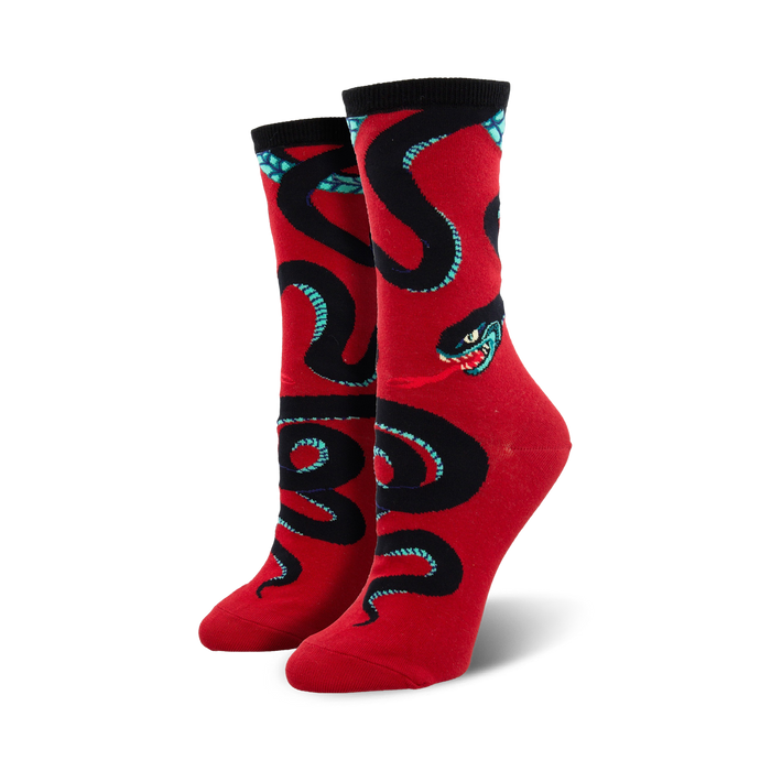 A pair of women's crew socks in red, adorned with a bold black and teal snake design. The snake is depicted in a coiled pattern. }}