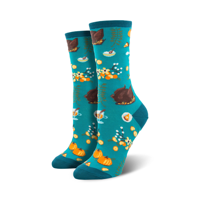 Pair of teal crew socks with a Thanksgiving-themed pattern: roasted turkeys, pumpkins, pie, and fall foliage.