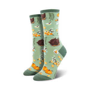 Close-up of a pair of sage green crew socks with the same Thanksgiving pattern as the teal socks.  Focus is on the design details.