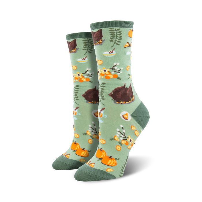 crew length women's socks featuring turkeys, pumpkins, pies, and leaves on a sage green background. perfect for thanksgiving.  