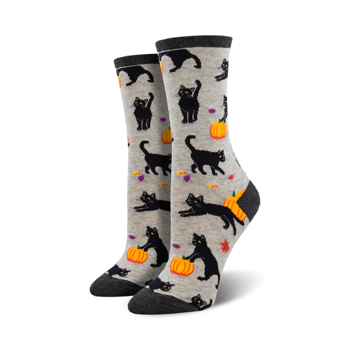 A pair of women's crew socks. Grey background with black cats and orange pumpkins. Halloween-themed. }}