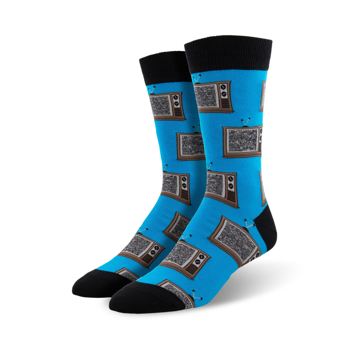 A pair of men's crew socks in bright blue, adorned with a pattern of retro brown and grey televisions. Black cuffs add a stylish contrast. }}
