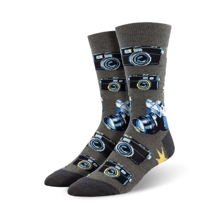 A pair of grey crew socks with a pattern of vintage cameras and lenses in blue and black. }}