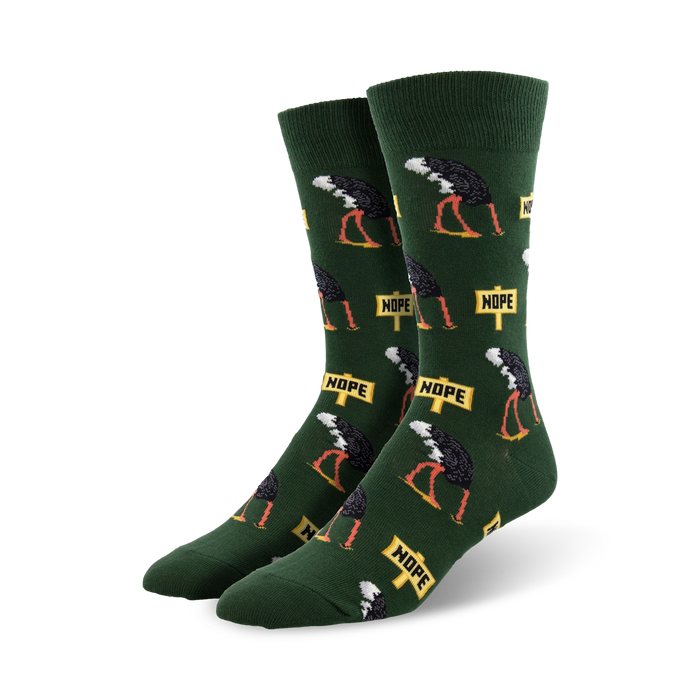 Pair of crew socks in green and gray featuring a repeating pattern of ostriches with 'Nope' signs. Fun, quirky design.