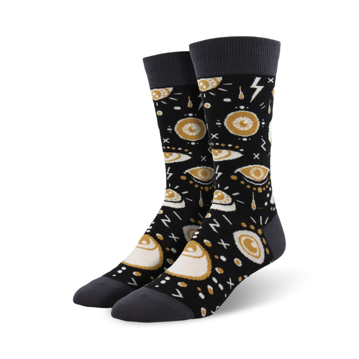 Pair of black crew socks with a gold and gray eye design. The eyes are surrounded by various symbols and patterns. }}