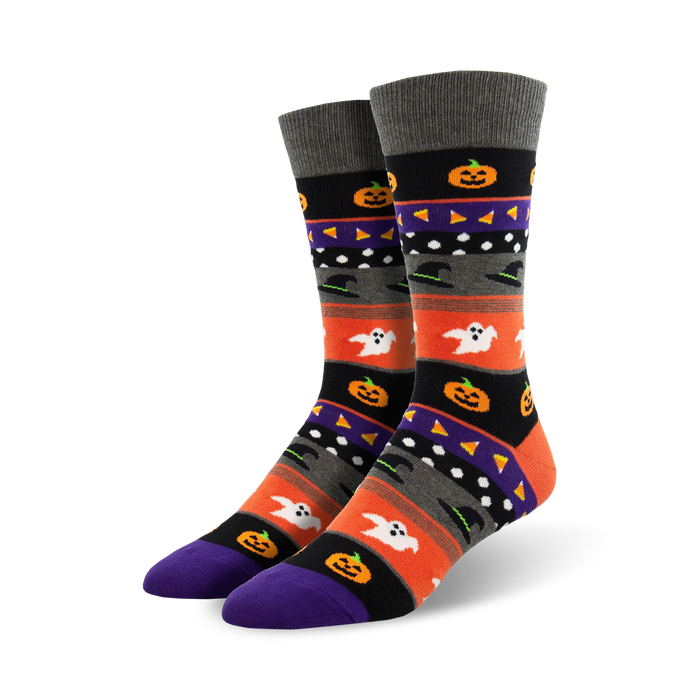 A pair of crew socks with a Halloween theme. The design includes orange, purple, black, and grey stripes with pumpkins, ghosts, and witches' hats. }}