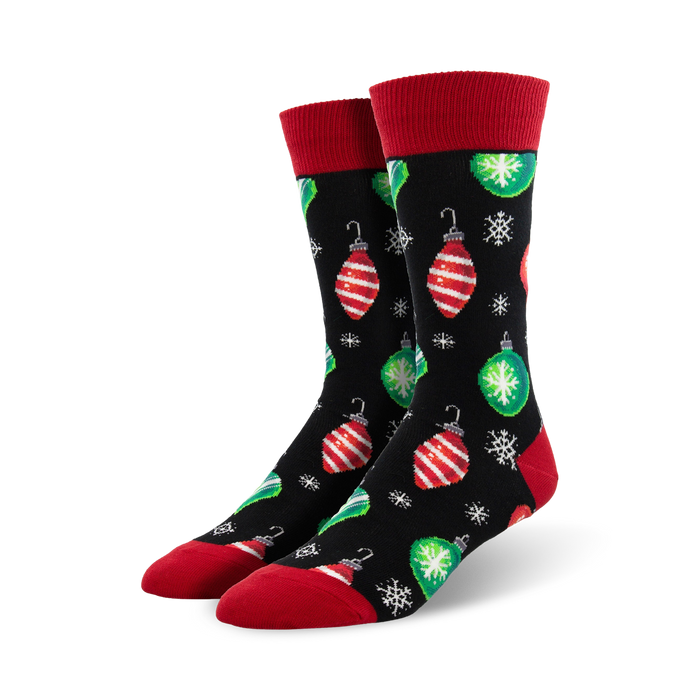 Pair of crew socks with a black background, red and green Christmas ornaments, and snowflakes. Red cuffs. }}