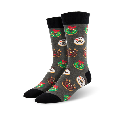 Crew socks in grey with a fun Christmas design. Features donuts decorated as wreaths, reindeer, and snowmen. Red, green, and white accents on a dark grey background.