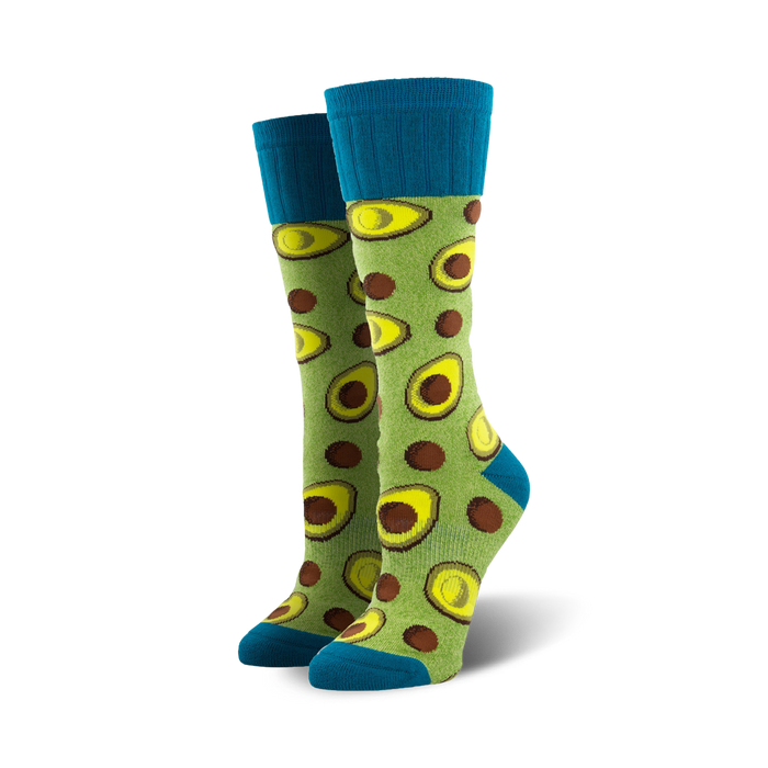 Pair of lime green crew socks featuring avocado slices and brown dots. Teal blue cuffs. }}
