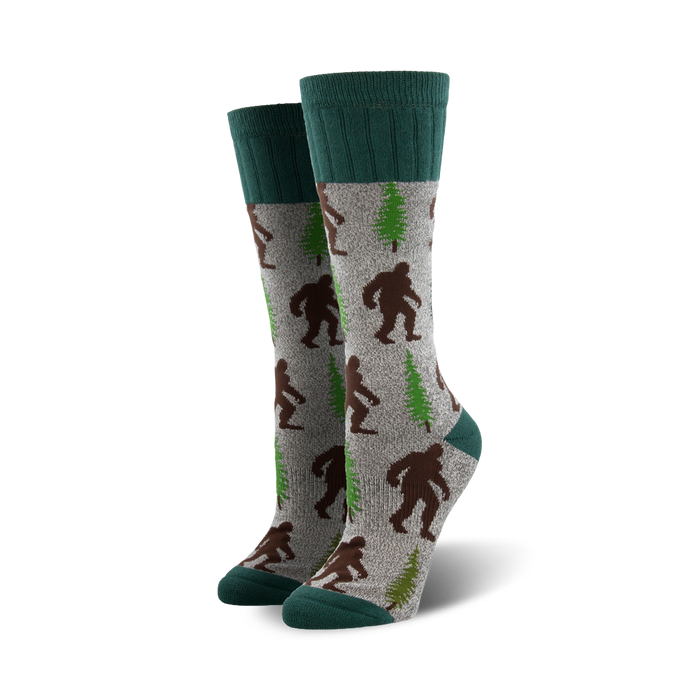 gray boot socks featuring brown bigfoot creatures and green pine trees }}