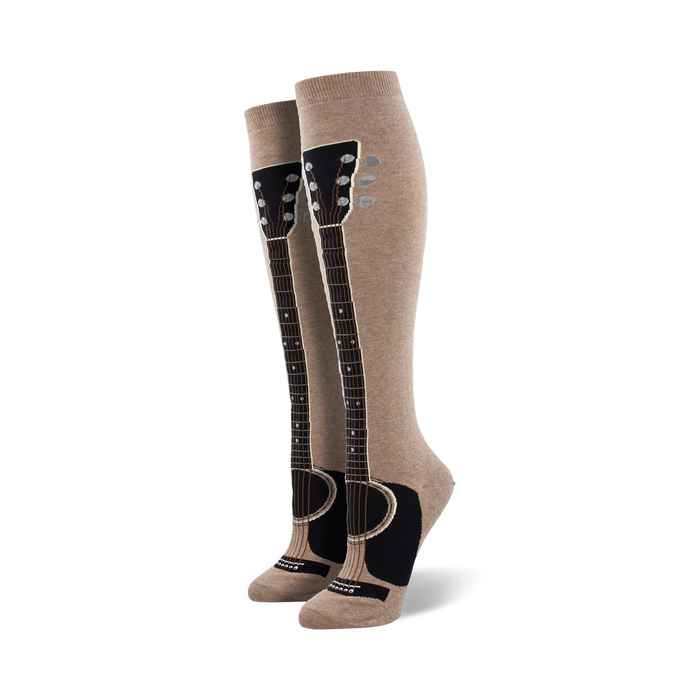Pair of taupe knee-high socks with a black guitar graphic running down the leg. The guitar neck features tuning pegs and the body is visible at the ankle. }}