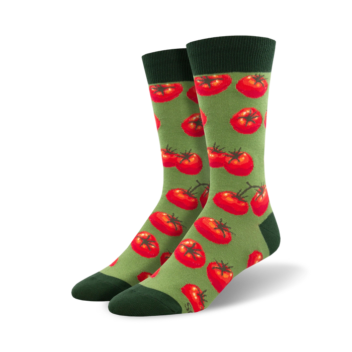 Pair of crew socks with a repeating pattern of red tomatoes on a green background.  Dark green cuffs.