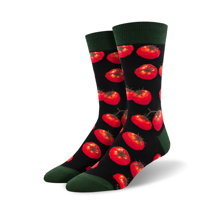 Close-up view of Toe-May-Toes socks with red tomatoes on a black background, showing the detail of the tomato pattern.
