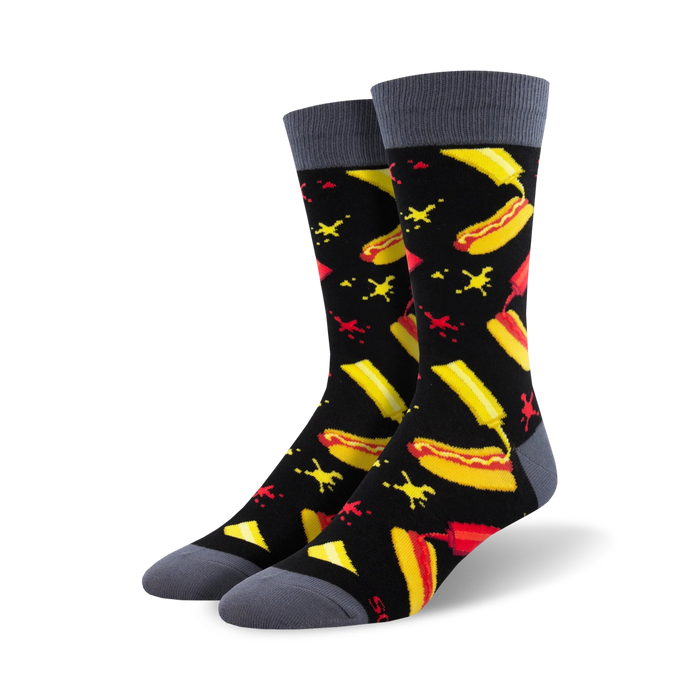 Pair of black crew socks with a fun hot dog, mustard, and ketchup design. The socks have grey cuffs. }}