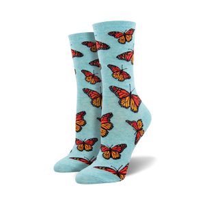 blue crew socks for women with an allover pattern of orange butterflies with black and white markings.   
