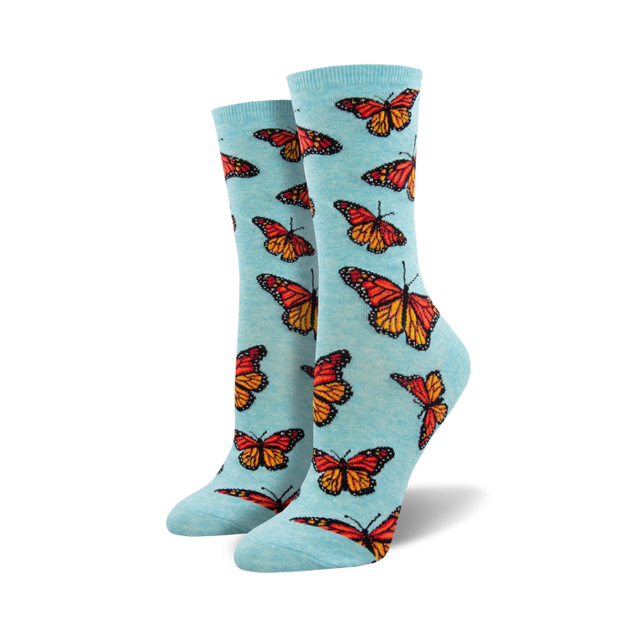 blue crew socks for women with an allover pattern of orange butterflies with black and white markings.   