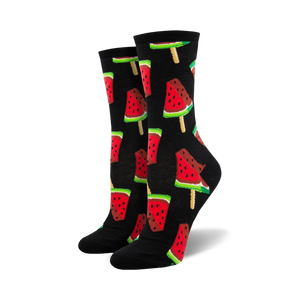 Pair of crew socks with a repeating pattern of watermelon popsicles.  The popsicles are red, pink, green, and black on a black or navy background.