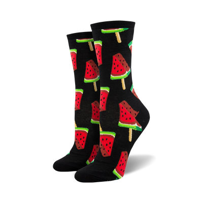Pair of crew socks with a repeating pattern of watermelon popsicles. The popsicles are red, pink, green, and black on a black or navy background.