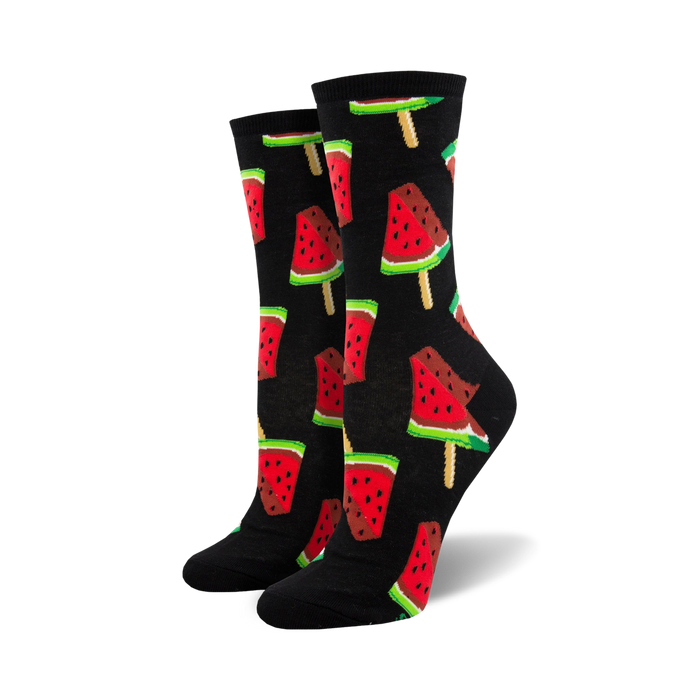 Pair of crew socks with a repeating pattern of watermelon popsicles.  The popsicles are red, pink, green, and black on a black or navy background.
