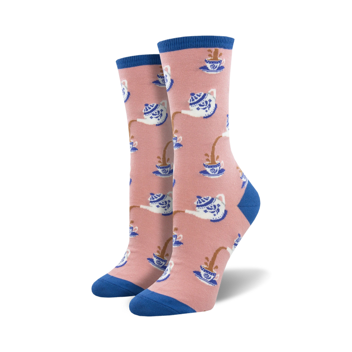 Pair of crew socks in pink and blue, featuring a pattern of teapots pouring tea into cups.