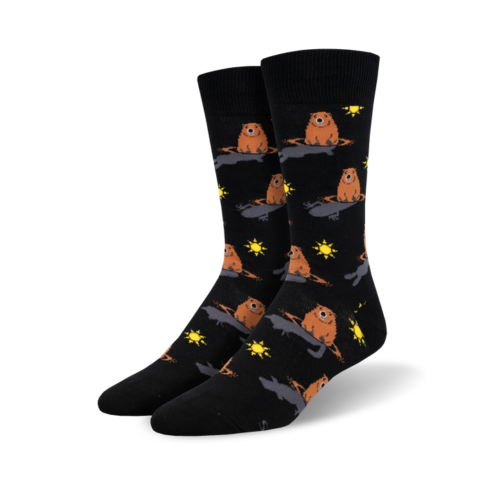 A pair of black crew socks with a repeating pattern of brown groundhogs emerging from holes, accented with yellow suns. }}