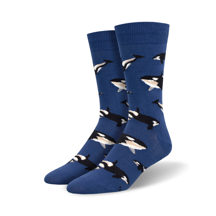 Pair of blue crew socks adorned with a repeating pattern of orcas in black and white. A fun, whimsical design. }}