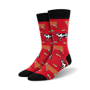 Pair of crew socks; red and black with repeating pattern of brown and black cows in a grassy field.