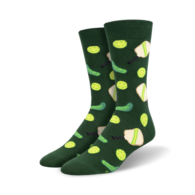 Pair of crew socks in hunter green with a repeating pattern of lime green pickleballs, paddles, and pickles.